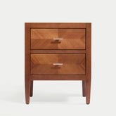 Krevon Wings solid wood nightstand in a dark walnut finish, featuring two drawers with a chevron wood grain pattern and modern tapered legs against a white background.