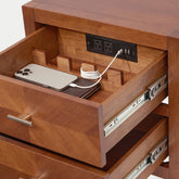 Interior view of a Krevon solid wood smart nightstand drawer featuring a built-in charging station with power outlets and USB ports, a smartphone in a dedicated wooden organizer, and soft-close metal glides