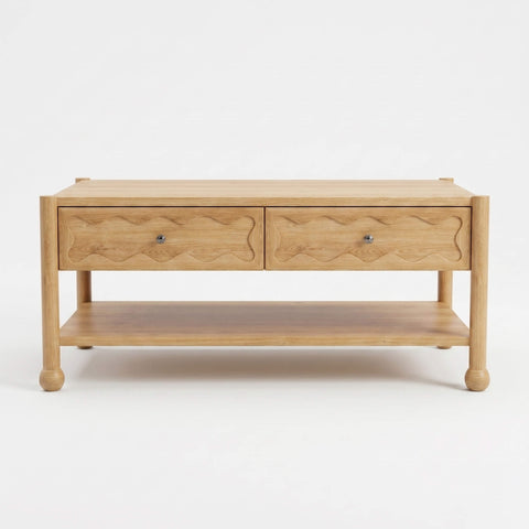 Front view of Arlo solid natural oak coffee table with two hand-carved wave motif drawer fronts and bun feet