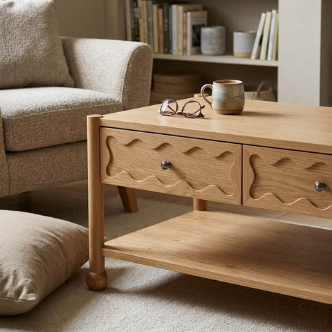 Arlo coffee table in natural oak with wave-carved drawers in a warm minimalist interior setting