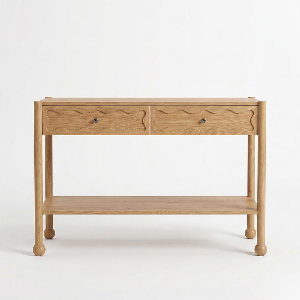 Front view of Arlo natural oak console table with two wave-carved drawers, open shelf, and bun feet