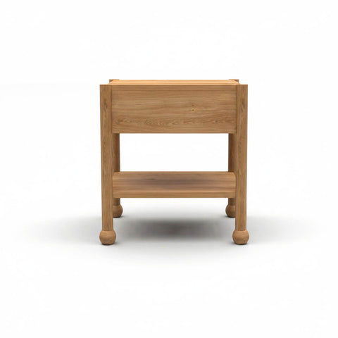 Rear view of Arlo solid wood side table in natural oak showing back panel and bun feet