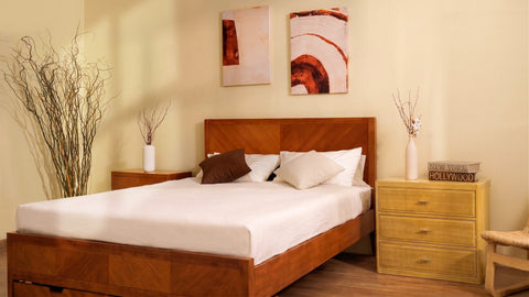Arlo 3-drawer fluted chest in natural oak styled in a bedroom with lamp and decorative accessories