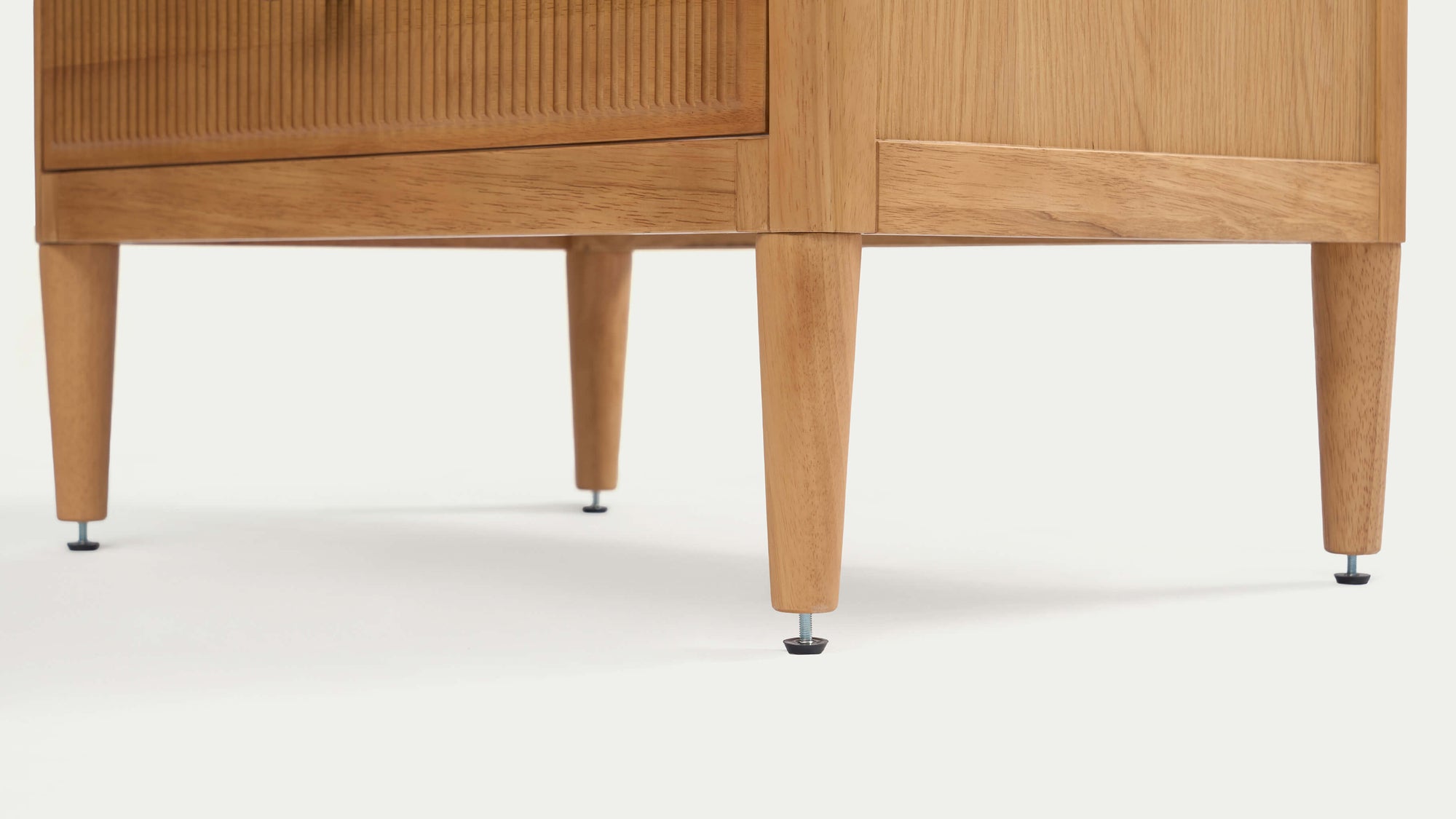 Close-up detail of the bottom fluted drawer front on the Arlo natural oak chest showing carved texture and wood grain