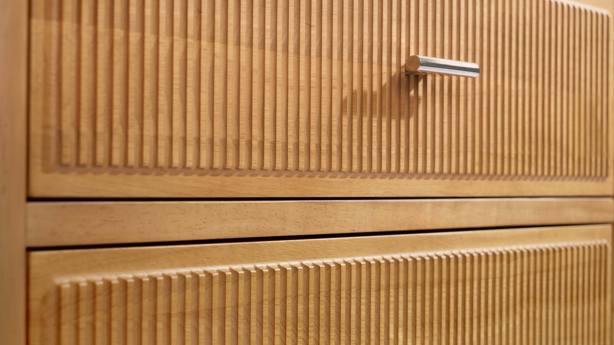 Detail shot of Arlo natural oak chest fluted drawer fronts highlighting the vertical groove pattern and natural oak finish
