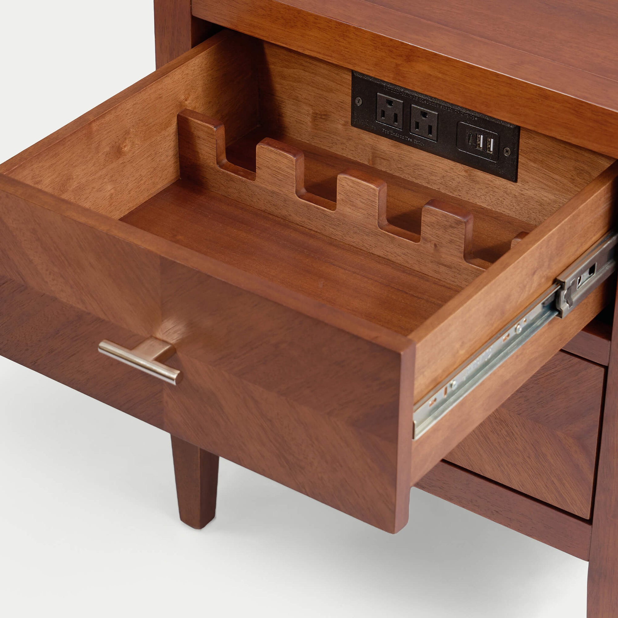 Interior view of a Krevon solid wood smart nightstand drawer, featuring a built-in charging station with power outlets and USB ports alongside a tiered wooden organizer