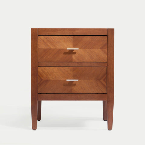 Krevon Wings solid wood nightstand in a dark walnut finish, featuring two drawers with a chevron wood grain pattern and modern tapered legs against a white background.