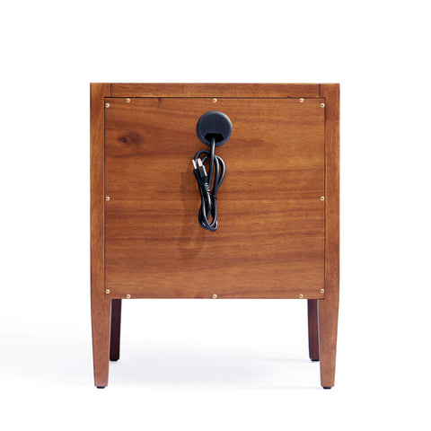 Rear view of a mid-century modern solid wood nightstand featuring a built-in cable management hole with a black grommet for organized cord storage