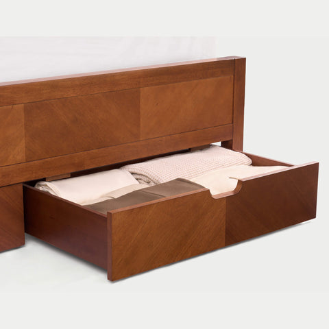 A KREVON Signature Series Acacia Wood Storage Bed, featuring a handcrafted herringbone geometric inlay headboard and footboard, with two integrated footboard drawers and an ergonomic curved solid wood slat support system.