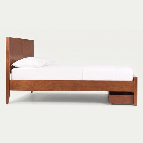 Side profile of the Signature Acacia Wood Platform Bed showcasing the low-profile architectural design and integrated footboard storage drawers